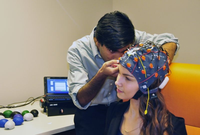 Researchers test a portable brain scanner developed by SFU professor Ryan D'Arcy, one of several health technologies evolving at the new Neurotech Lab at Surrey Memorial Hospital.